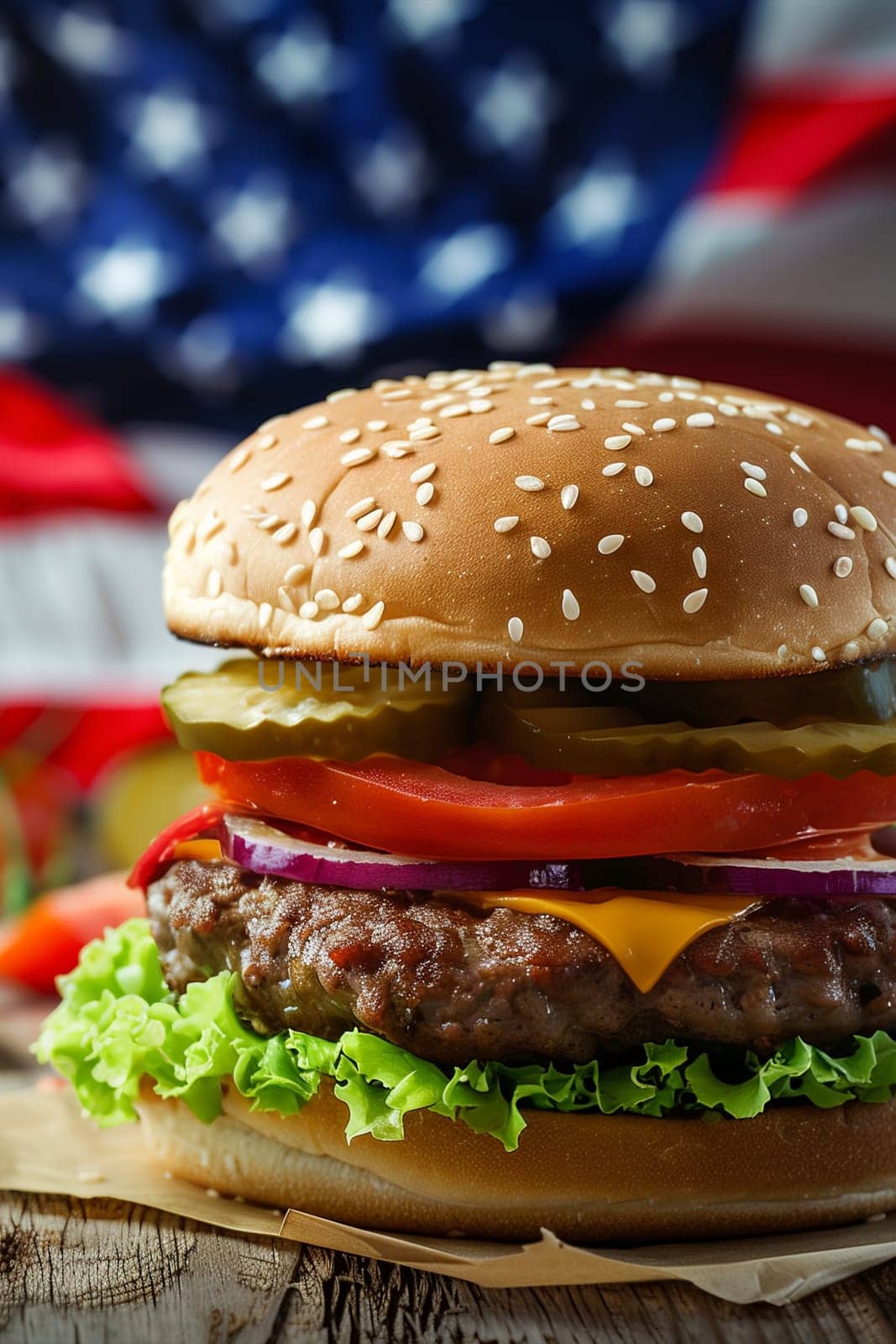 A hamburger is placed on top of a wooden table, showcasing a classic fast food meal ready to be enjoyed.
