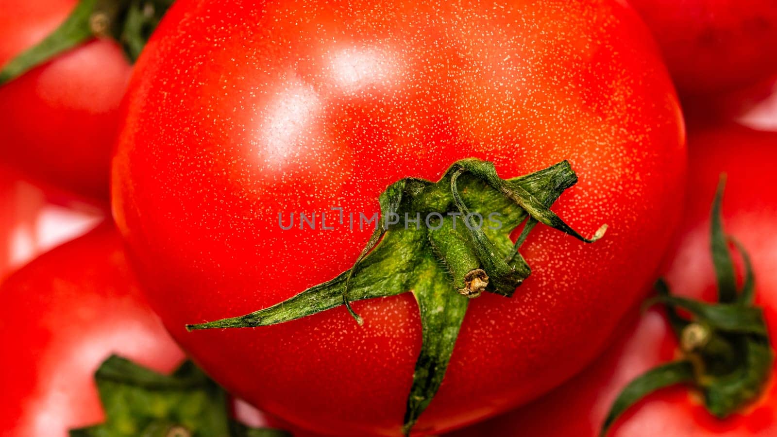 Close up of ripe red tomato, tomatoes background.