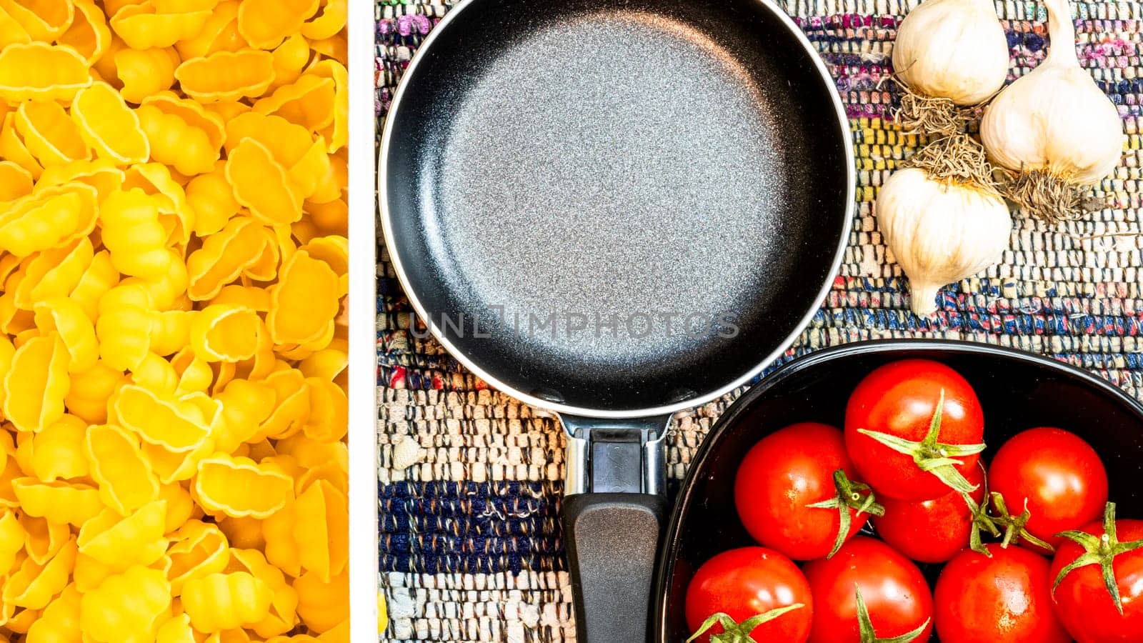 Beautiful tasty Italian pasta, tomatoes, onions and garlic for cooking pasta