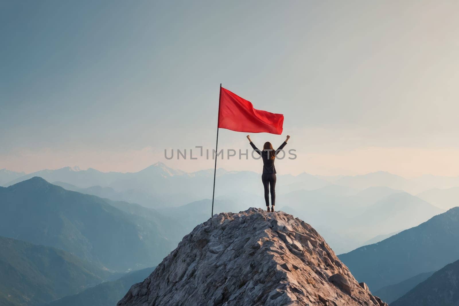 A triumphant individual standing atop a mountain holding a red flag demonstrates victory. Perfect for motivational, success or extreme sport themes.