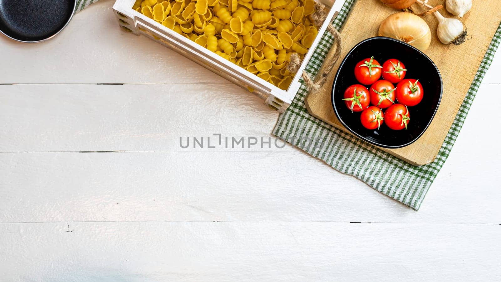 Beautiful tasty Italian pasta, tomatoes, onions and garlic for cooking pasta by vladispas