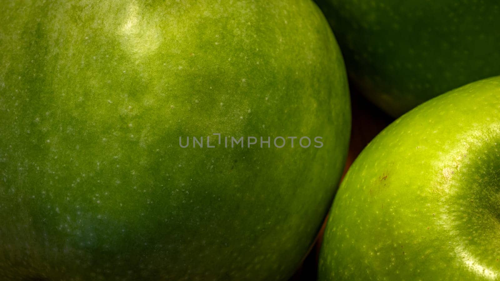 Close up photo of green apples on a wooden board. by vladispas