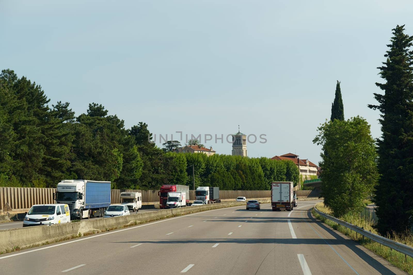 Vaugry Gard, France - May 30, 2023: A long convoy of trucks is seen moving down a busy highway, each vehicle following the one in front, as they transport goods to their respective destinations.