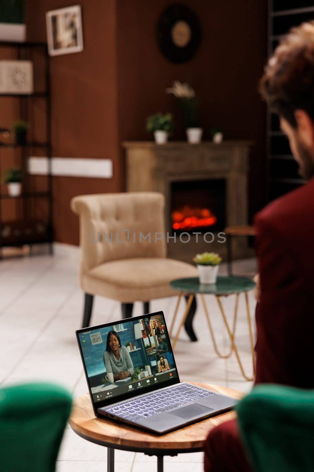 White collar worker on videocall in lobby, attending business conference online in lounge area at luxury hotel. Entrepreneur using laptop to chat on teleconference, waiting for check in.