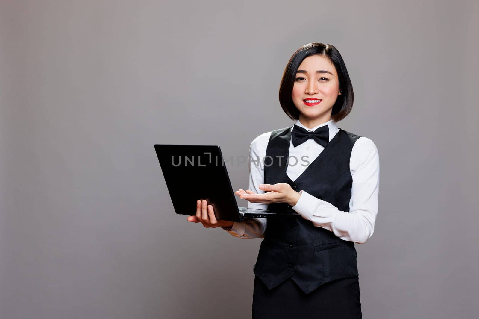 Waitress showing laptop portrait by DCStudio