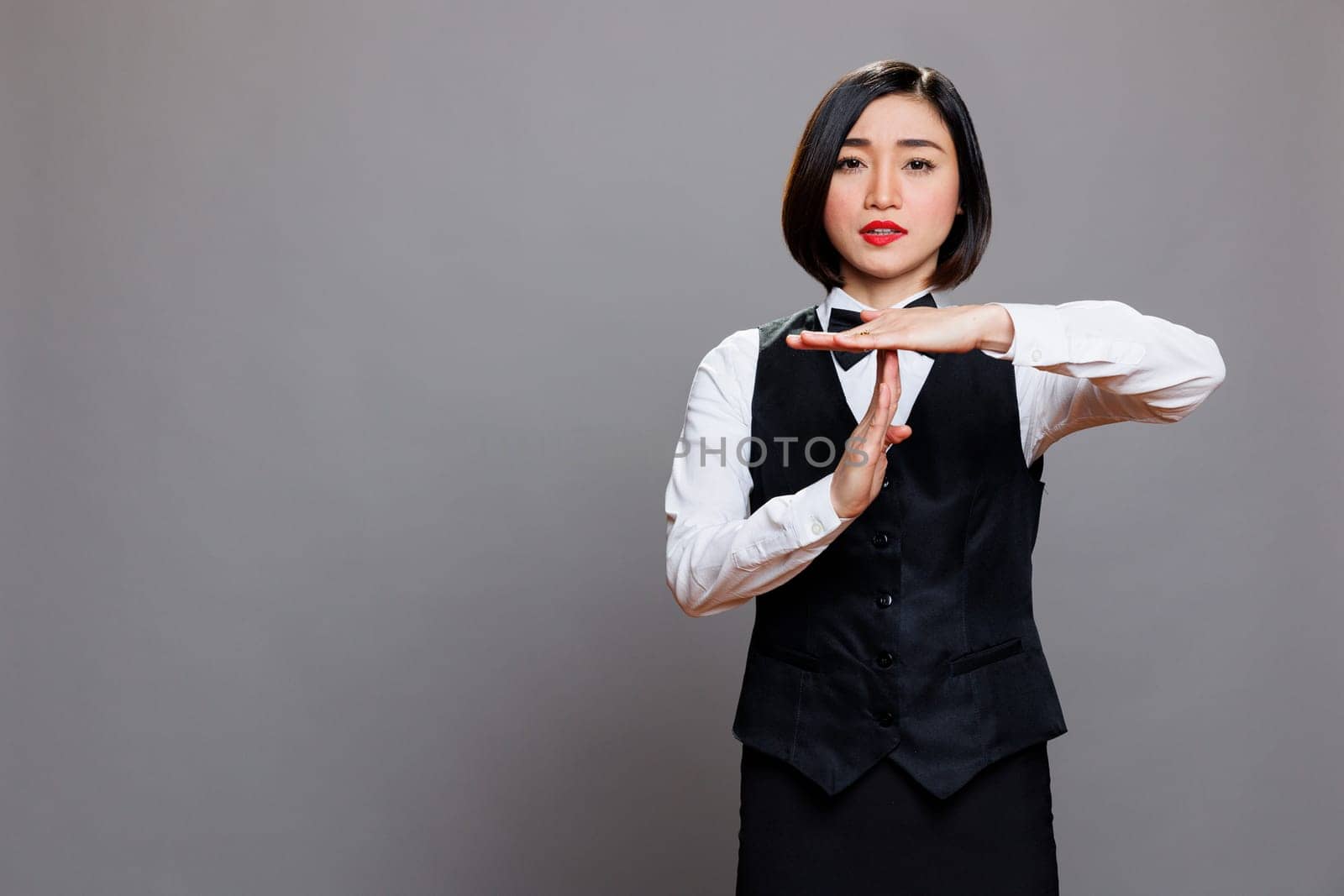 Asian waitress showing time out gesture by DCStudio