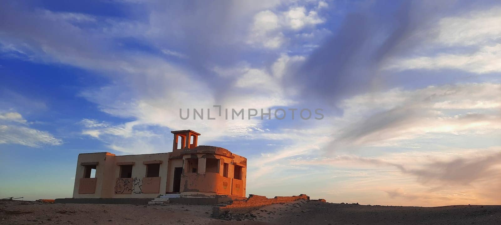 old architecture in Egypt, cloudy sky over the destroyed building, dramatic clouds during sunset twilight by Costin