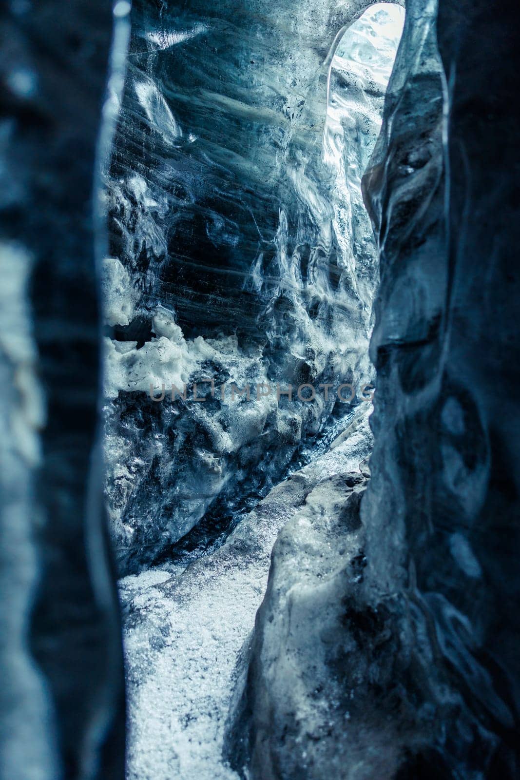 Ice rocks melting in iceland, global warming concept. Icy blocks with cracked transparent structure inside vatnajokull glacier crevasse, icelandic landscape in frosty ice caves.
