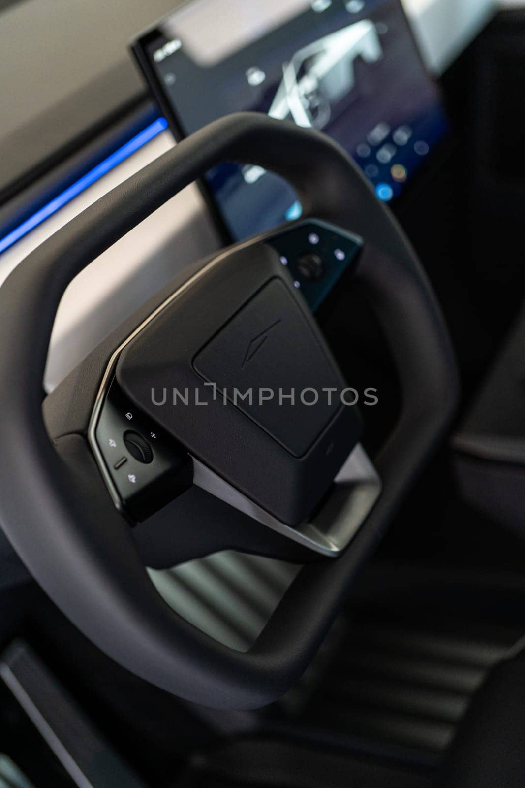 Denver, Colorado, USA-May 5, 2024-This image captures the futuristic interior of the Tesla Cybertruck, focusing on the steering wheel and its integrated control panels, highlighting the vehicle advanced technology.