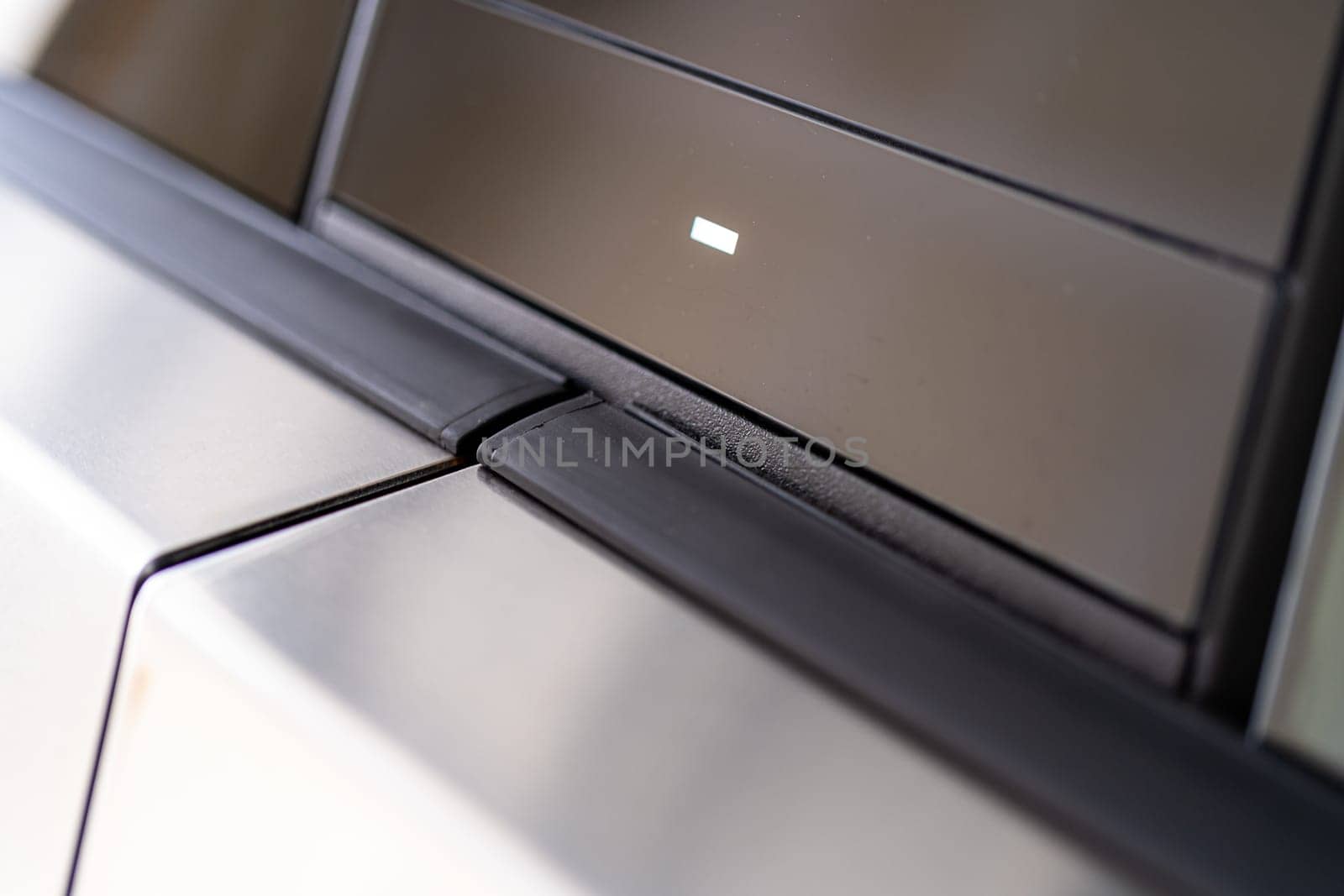 Denver, Colorado, USA-May 5, 2024-This image provides a close-up look at a car door opener, showcasing the clean lines and modern design typical of contemporary vehicle interiors. The focus on the mechanism highlights its sleek, minimalist style.