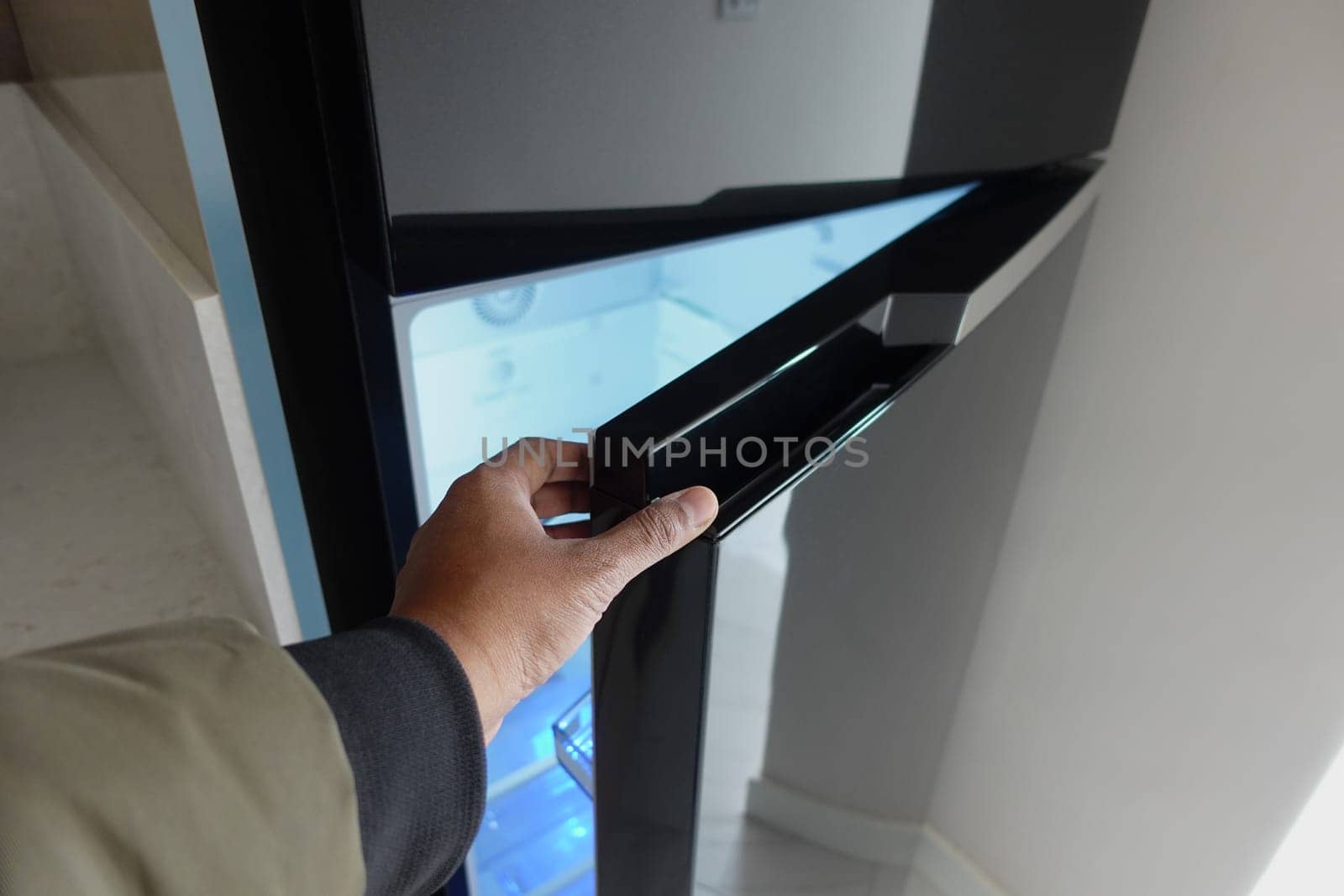 Man hand open empty fridge door by towfiq007
