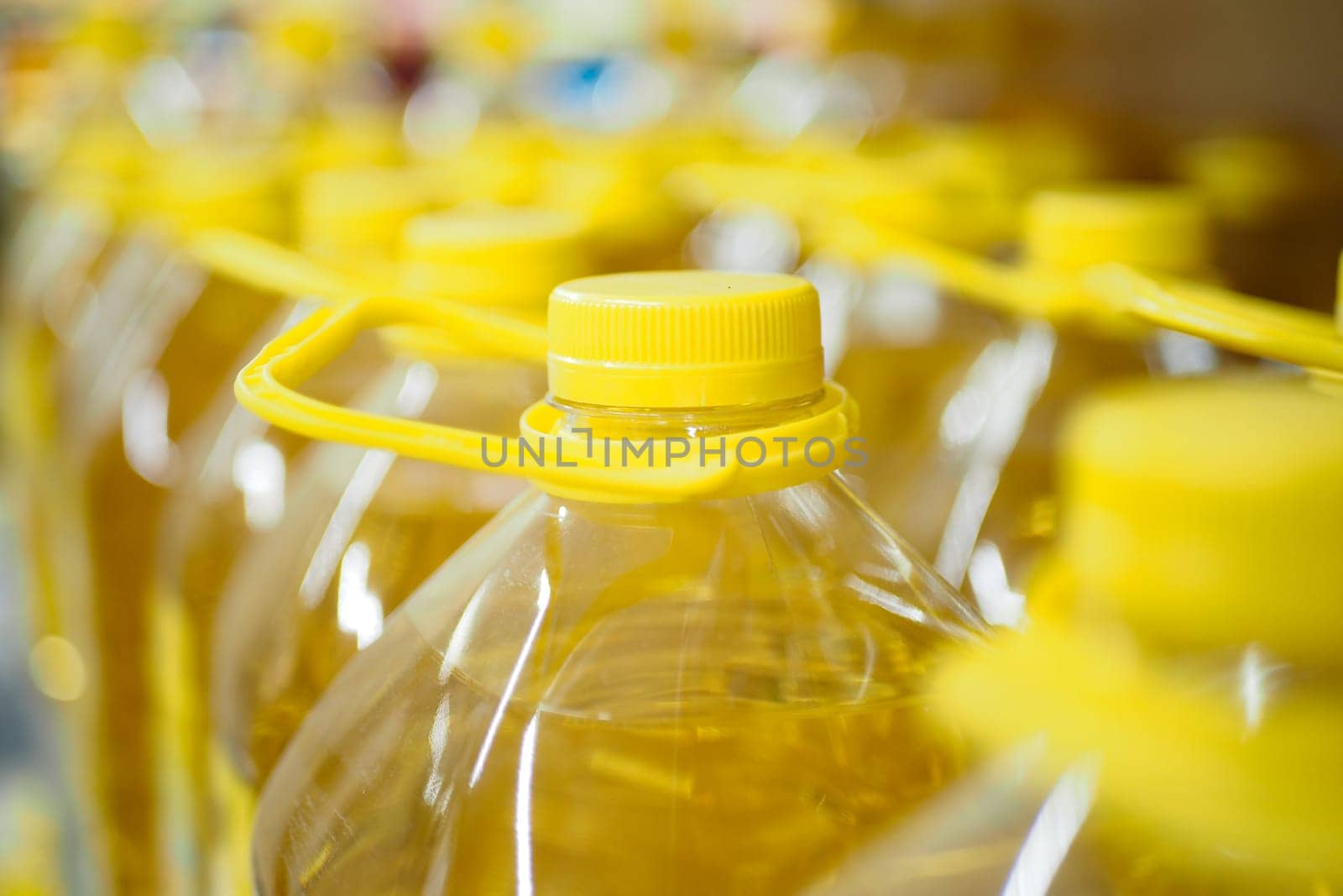 yellow sunflower oil bottle lined up in a store by towfiq007