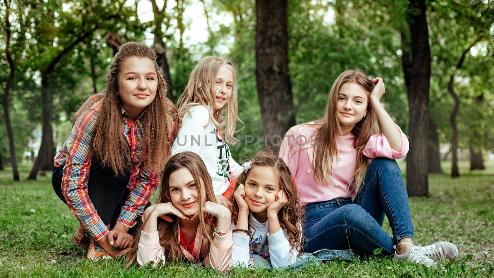 A group of girls' children pose on the lawn in the park. Yaremche, Bukovel, Ukraine - January 10, 2022