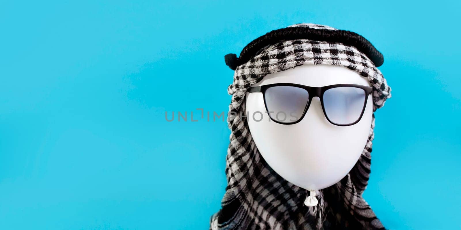 Balloon traveler in sunglasses and arafat concept tourist in Dubai or Egypt.