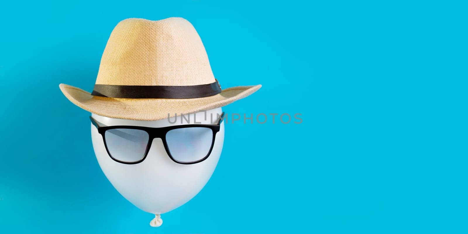 Balloon tourist close-up. The image of a male traveler in a hat and sunglasses concept tourist destination by malyshph
