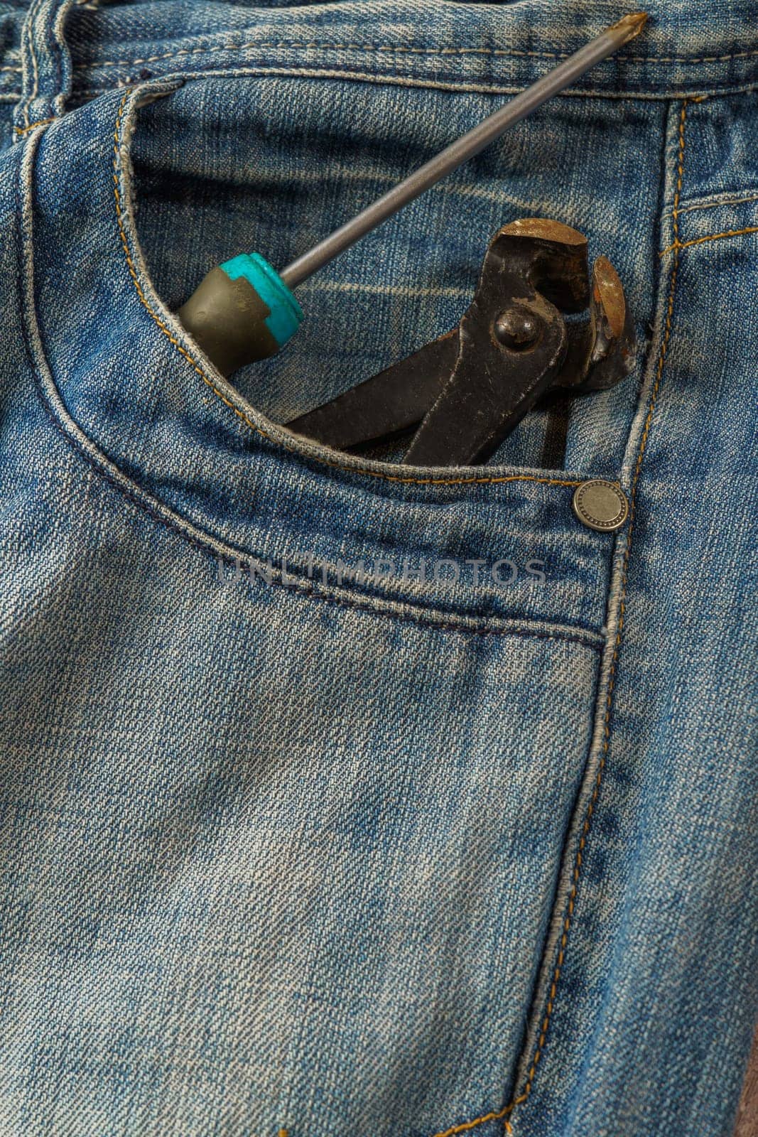 jeans with tools sticking out of pocket by joseantona