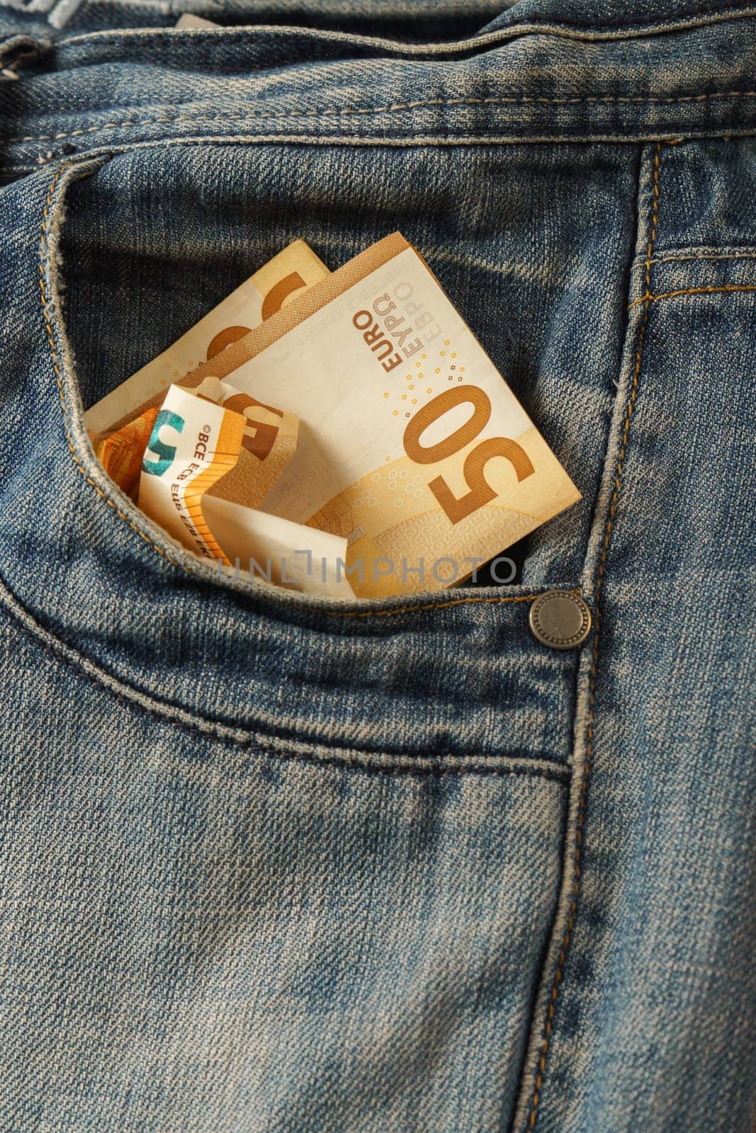jeans with euro banknotes coming out of the pocket by joseantona