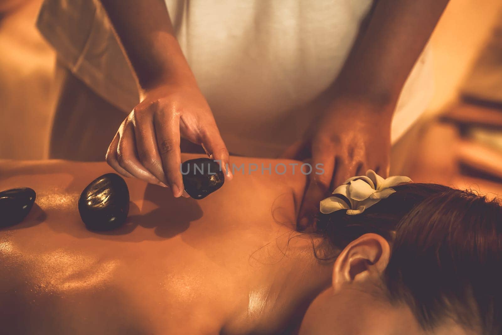 Hot stone massage at spa salon in luxury resort with warm candle light.Quiescent by biancoblue