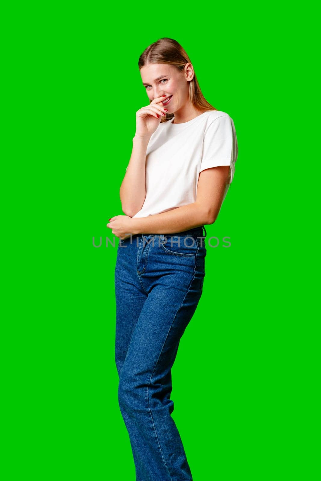 Smiling Young Woman in Casual Outfit Posing Against Green Background by Fabrikasimf