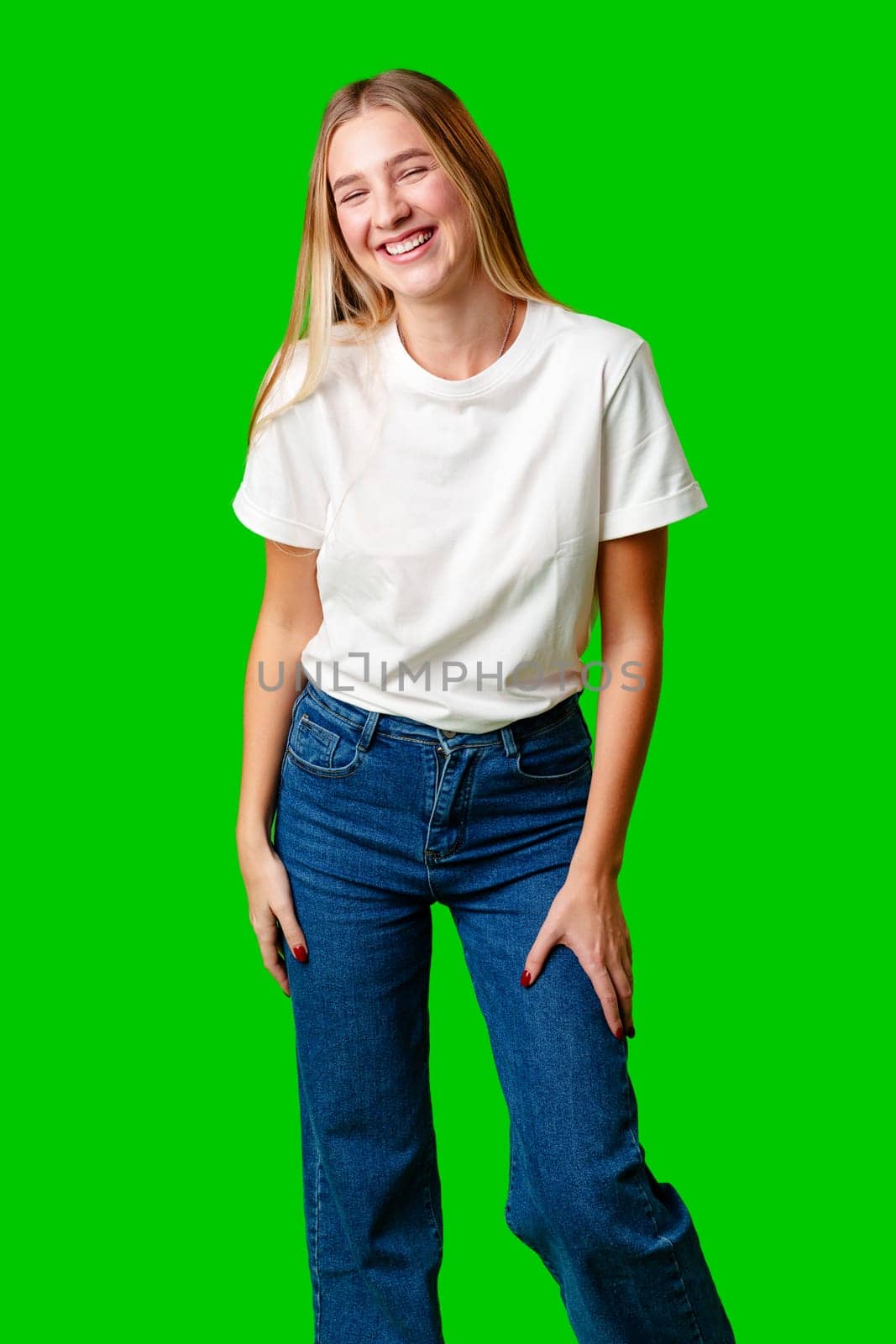 Young Woman Poses for Picture against green background in studio