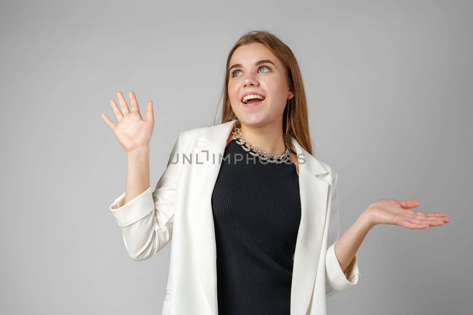 Excited Young Woman in Stylish Outfit Surprised Expression in Studio