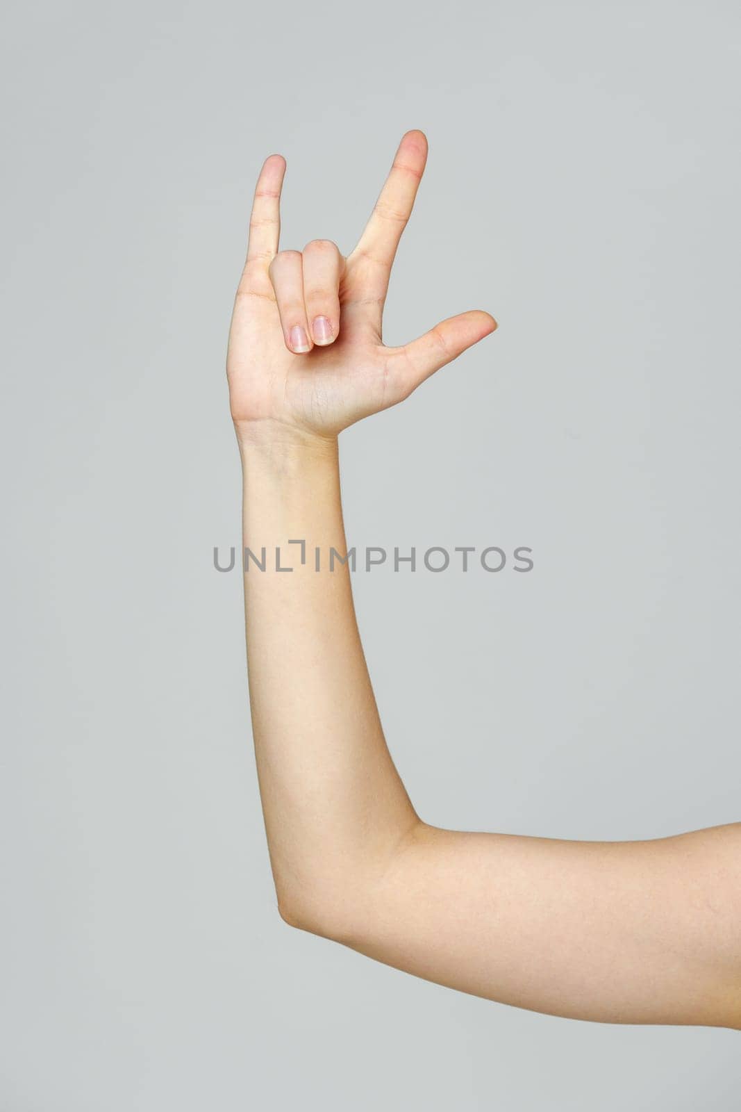 Young Woman Arm with Gesture close up on gray background