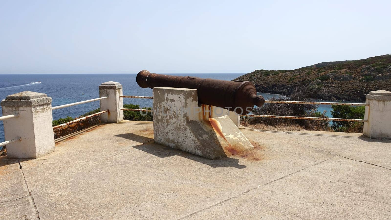 Ancient cannon on one of the Asinara sea viewpoints in Sardinia, Italy. During a summer day.