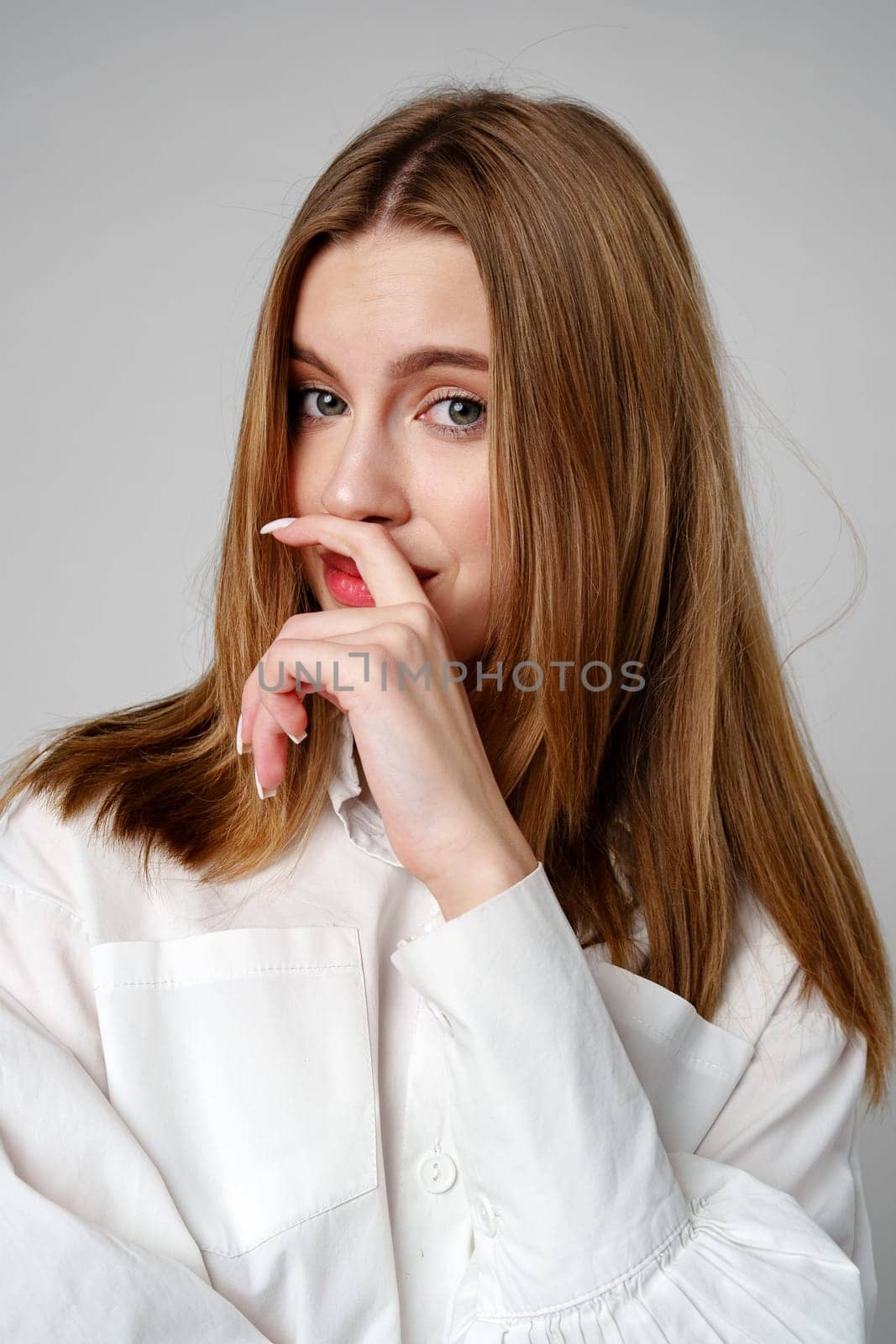 Concerned Young Woman deep in thought or contemplation on gray background