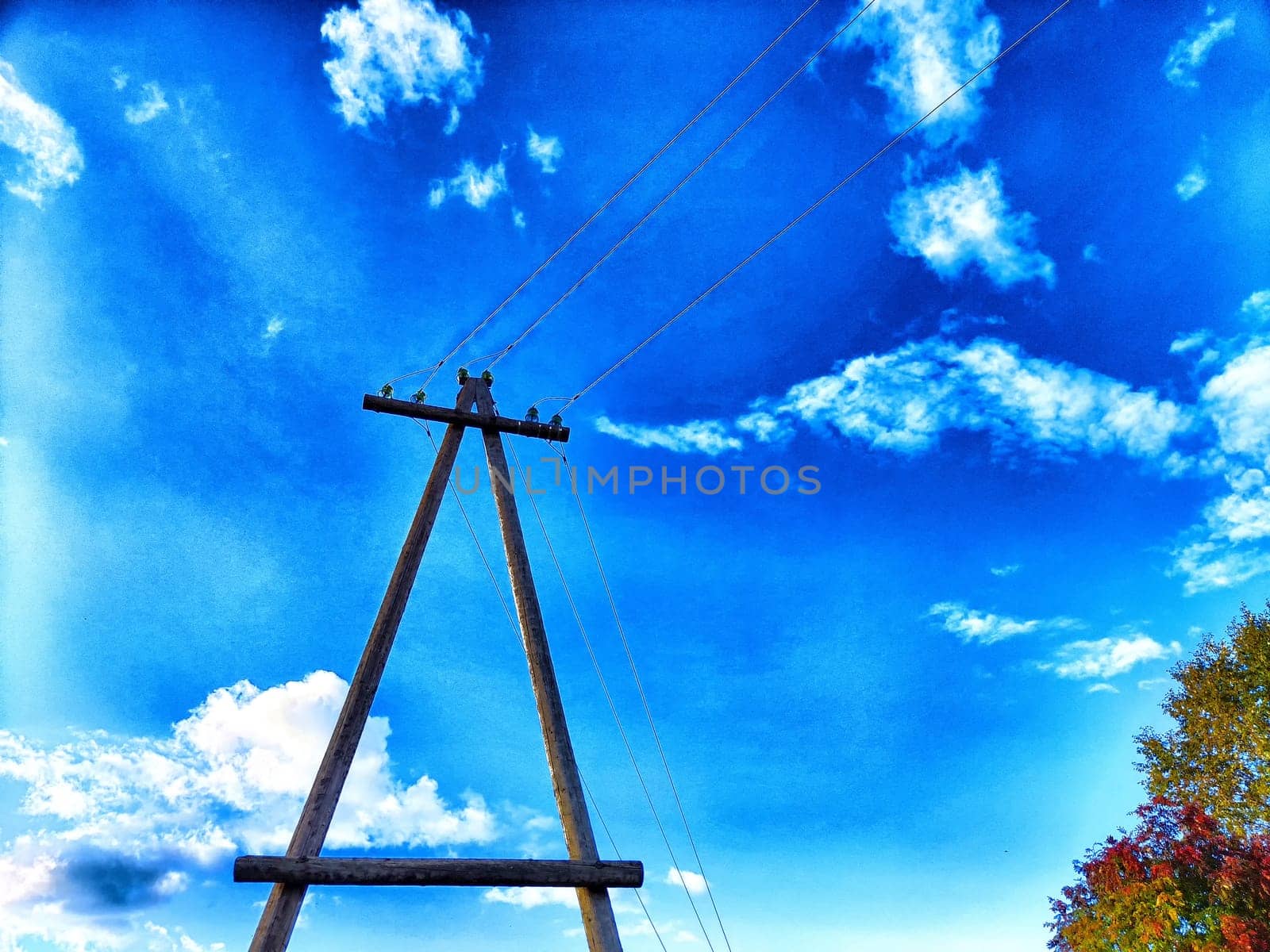 Old pole with wires against the sky. Electric transmission line. Eco-friendly energy by keleny