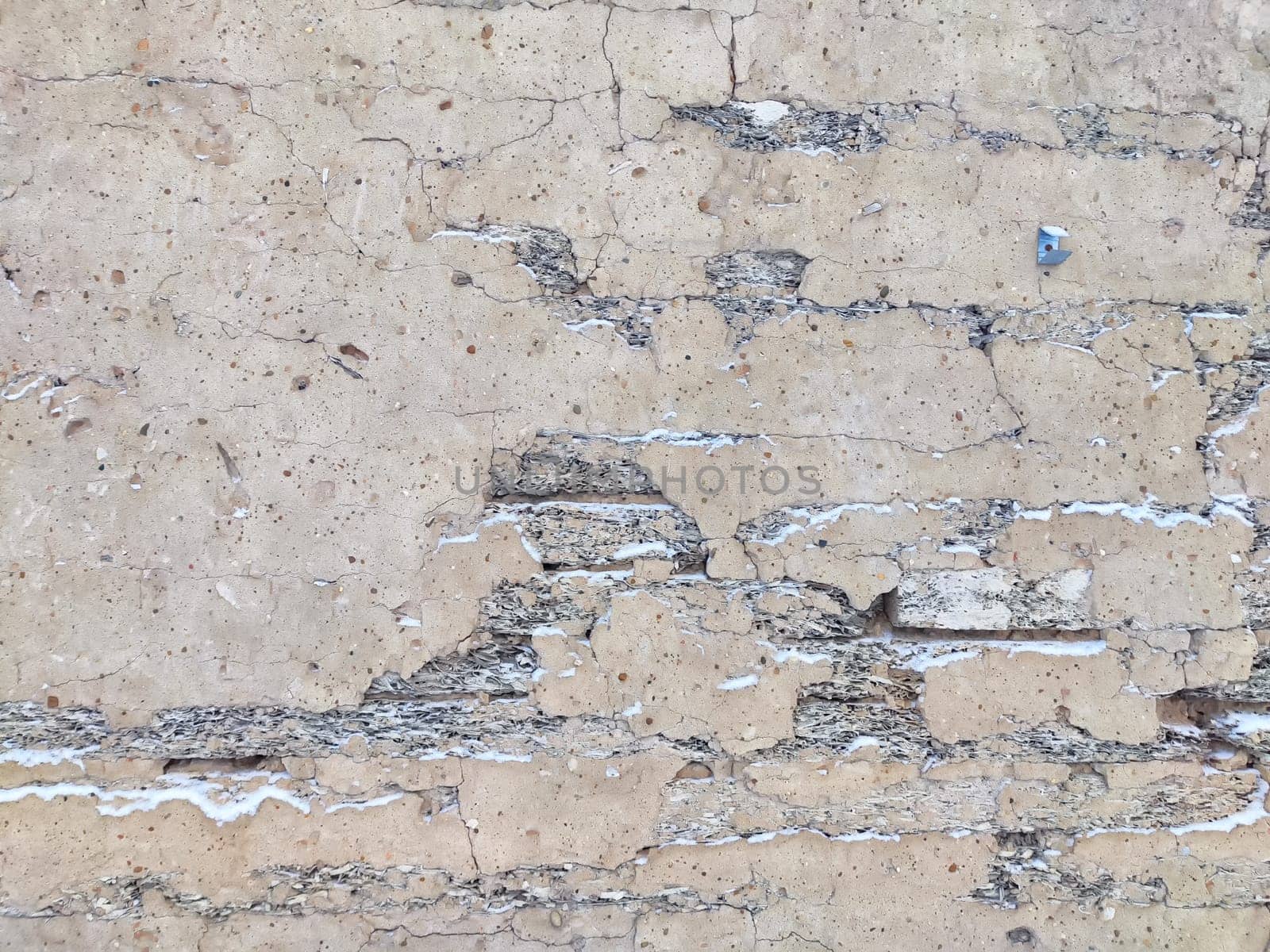 Background, texture of concrete wall. Weathered Concrete Wall Showcasing Signs of Aging and Erosion. Aged concrete wall with cracks and peeling layers