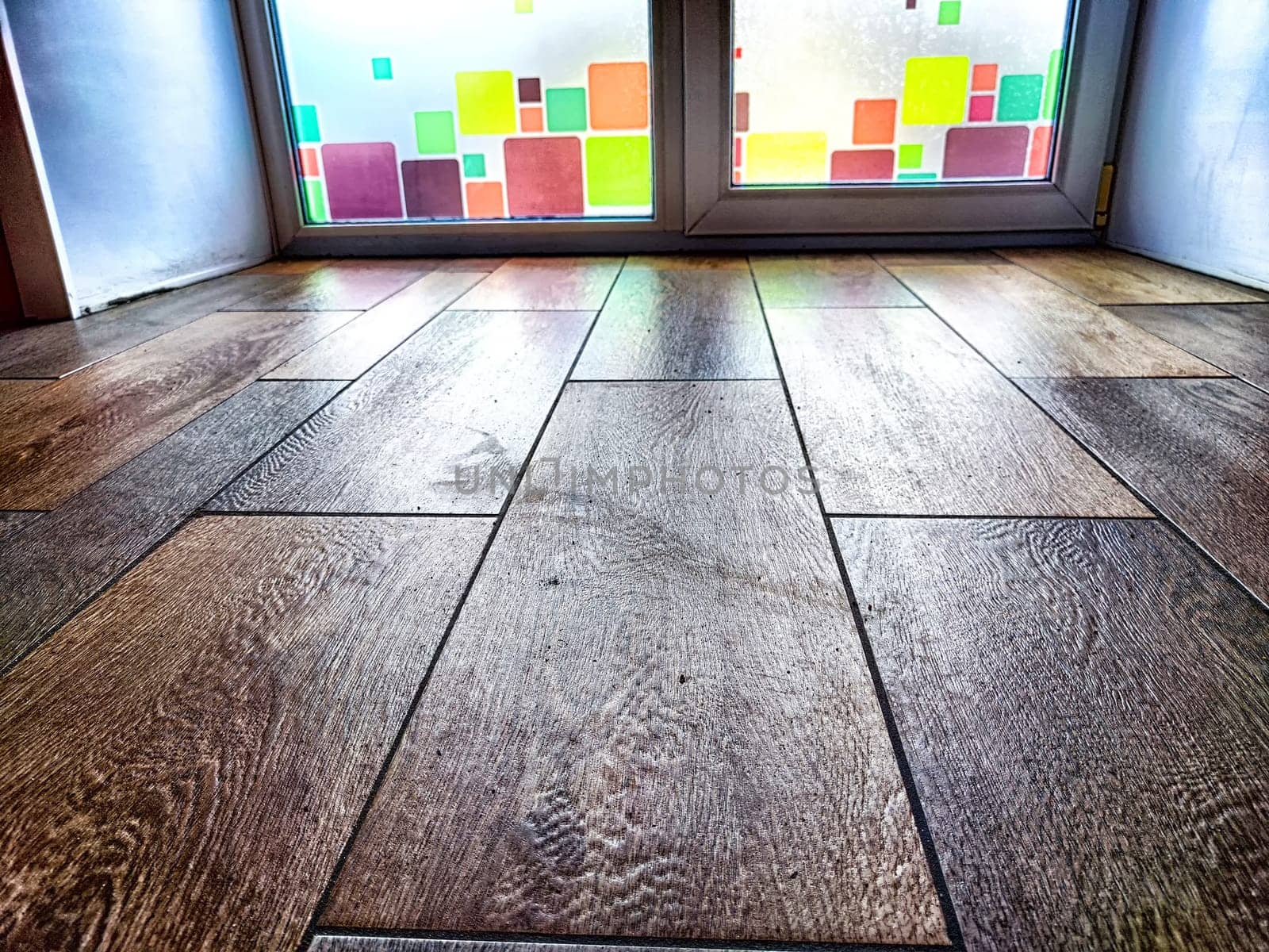 Window and floor. Background, texture. Frosted Glass Door With Colorful Square Details in a Wooden Interior by keleny