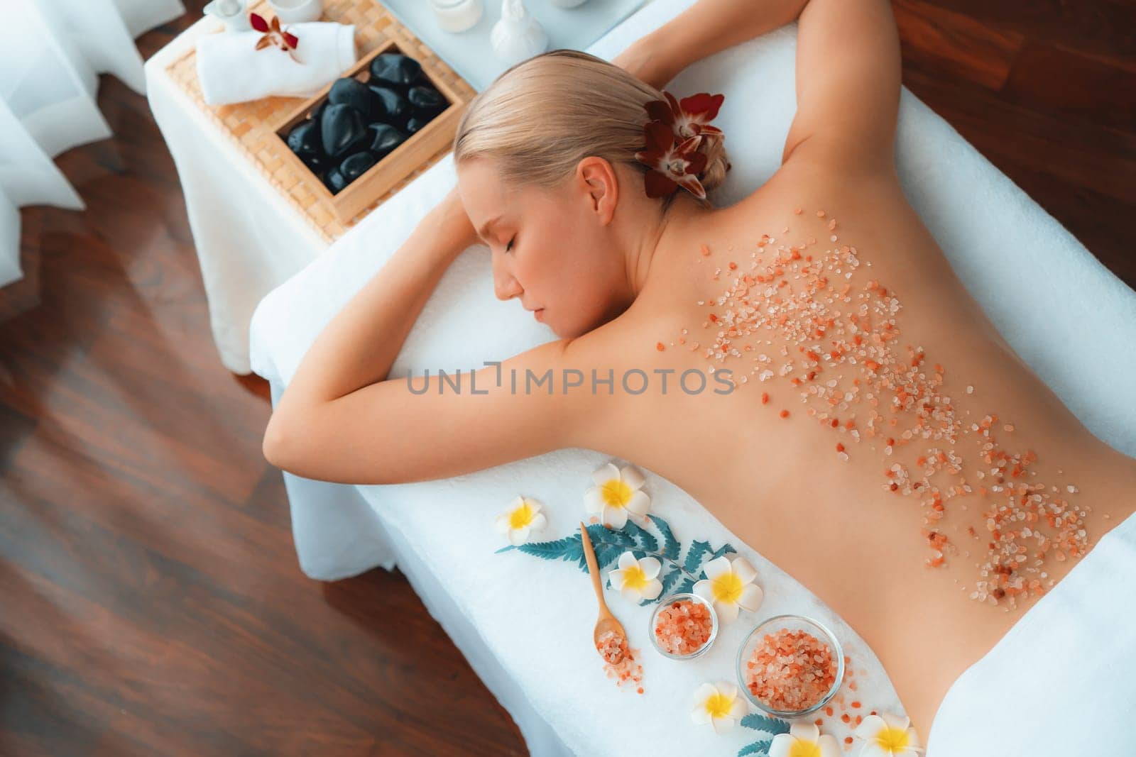 Woman customer having exfoliation treatment in luxury spa. Quiescent by biancoblue