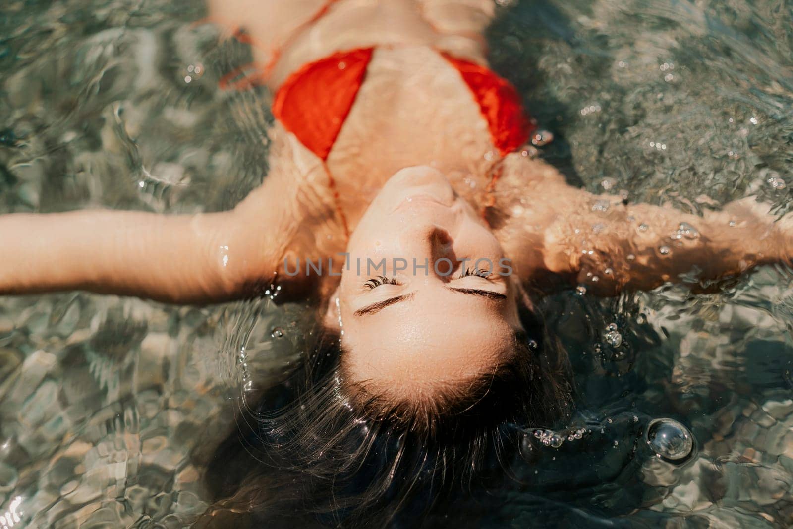 Happy woman sea relaxing floating in transparent sea water on summer holiday. Travel leisure recreation lifestyle, female in nature