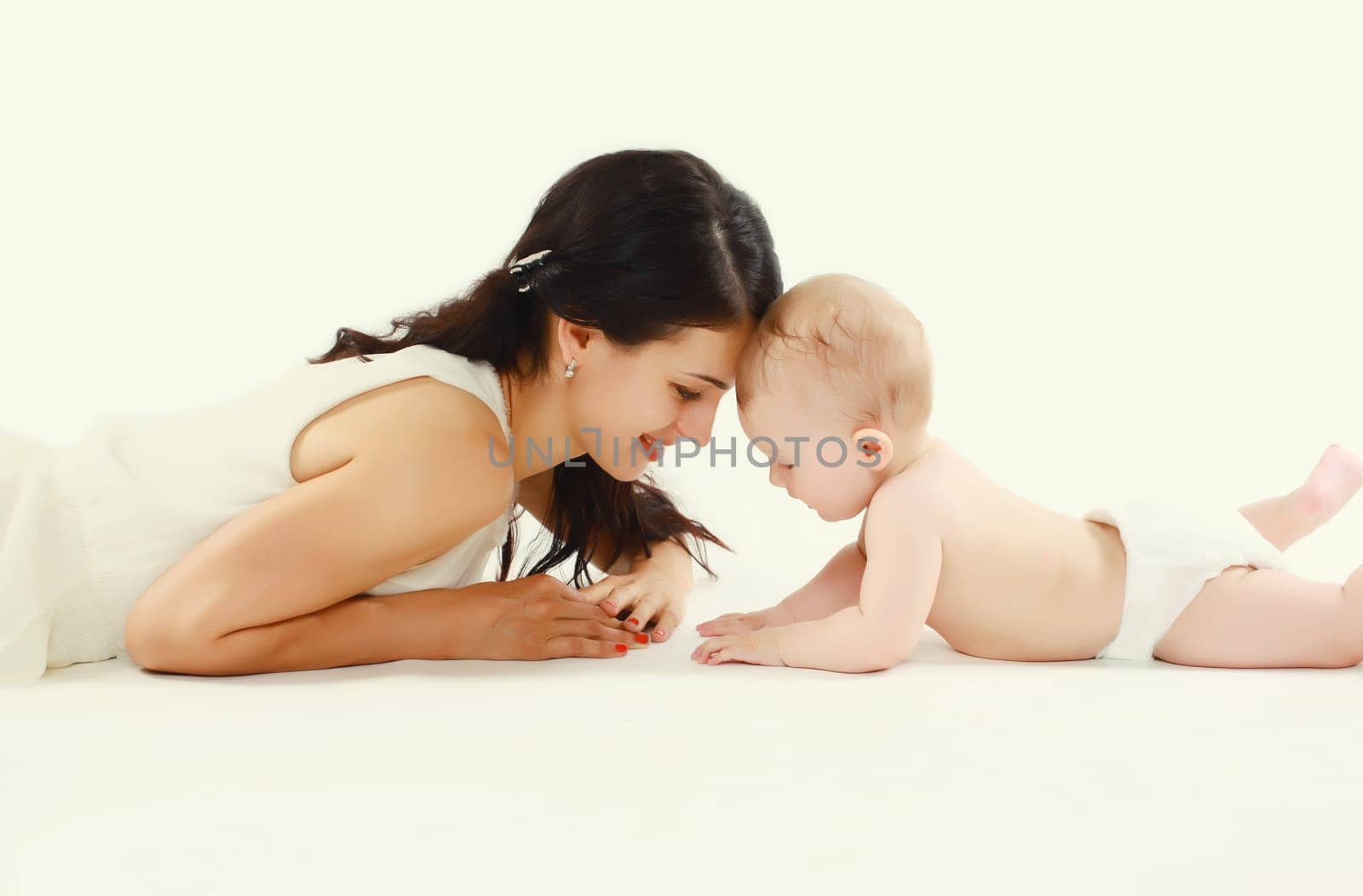 happy young mother playing with baby lying on the floor by Rohappy