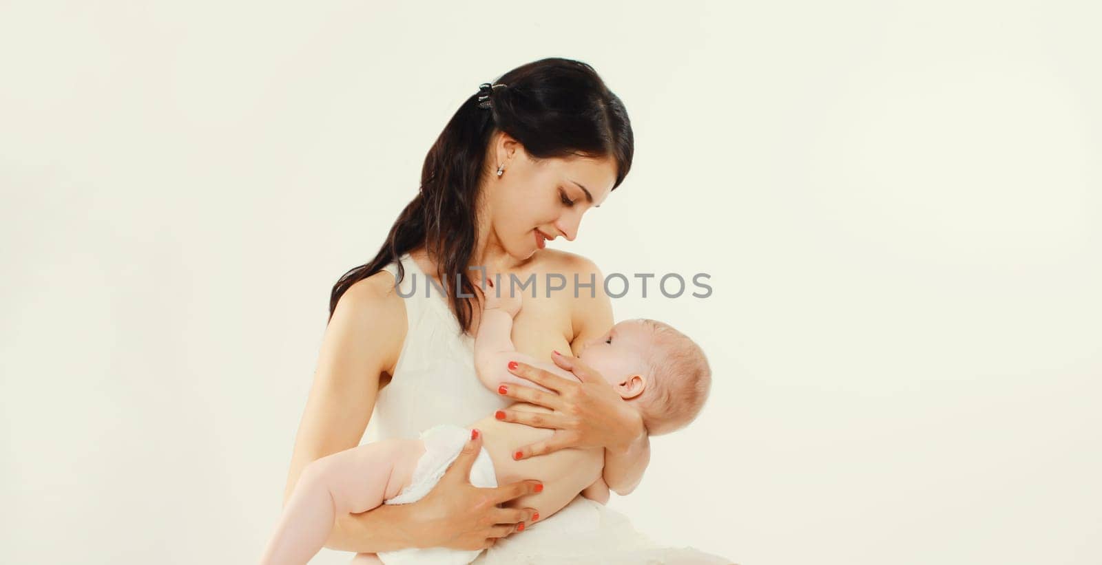 Happy mother breastfeeding her baby on white background by Rohappy