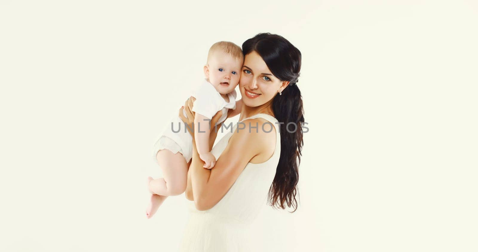 happy young mother holding baby on white studio background by Rohappy