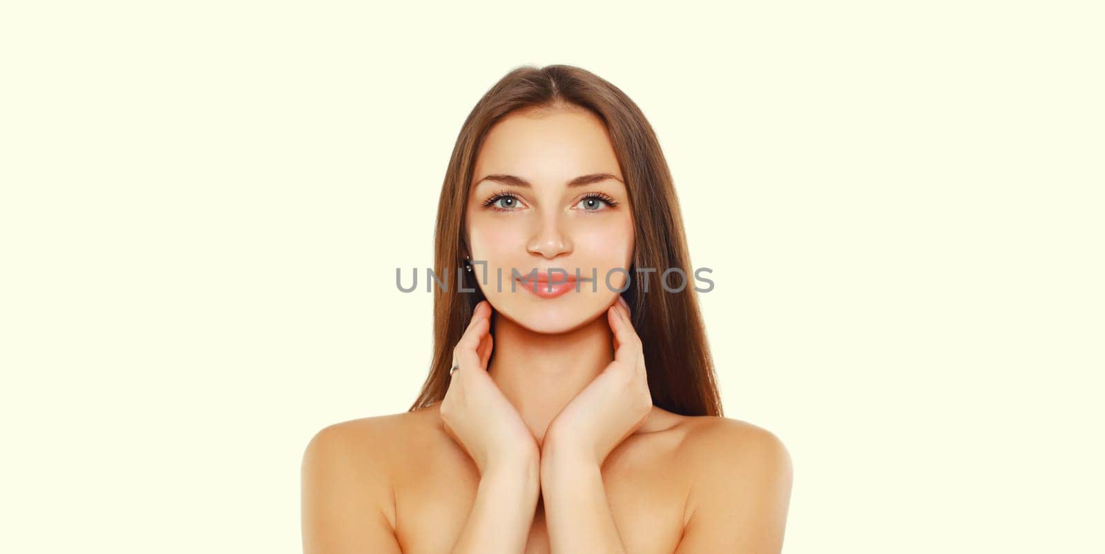 Beauty portrait of brunette smiling young woman on white studio background