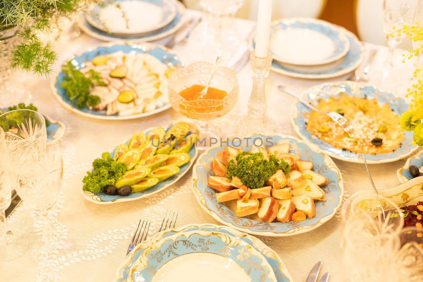 large and generously covered with delicious dishes table, covered with a tablecloth on which there are various delicious dishes of Ukrainian cuisine: salads, cheese.