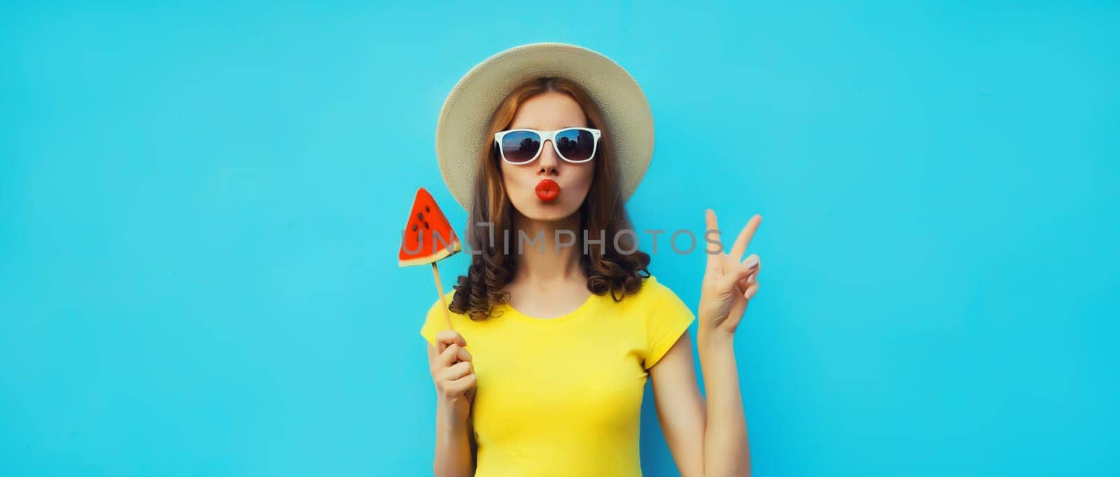 Summer portrait of stylish young woman with juicy lollipop or ice cream shaped slice of watermelon by Rohappy