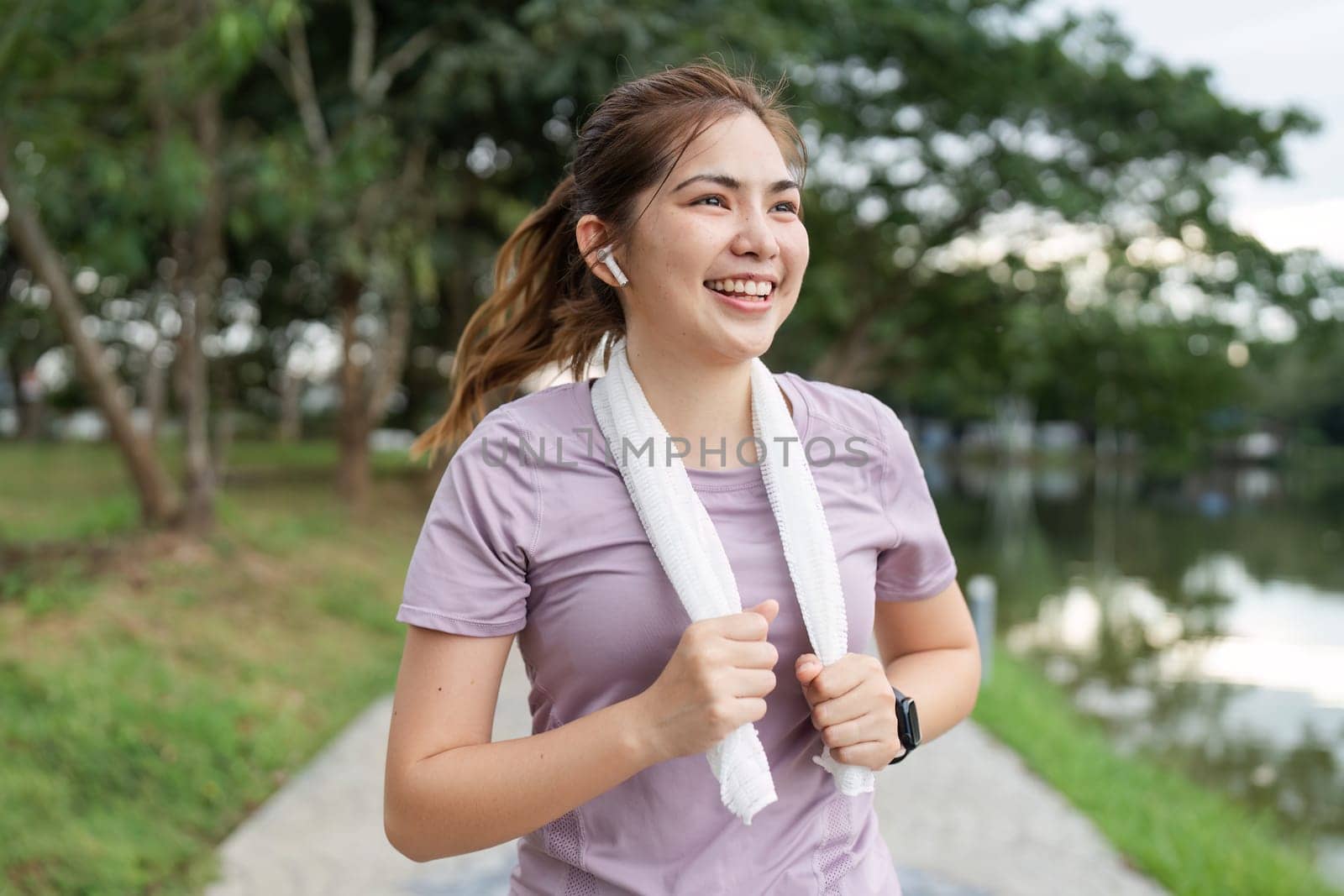 Running woman. Female Runner Jogging during Outdoor Workout in a Park. Healthy lifestyle. Morning.