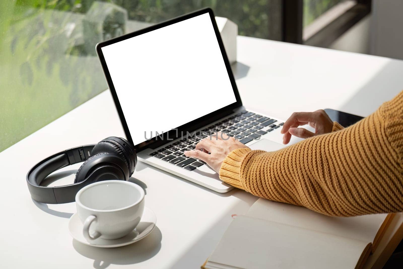 Young female with laptop at home on white blank screen for montage mockup display device in concept of lifestyle work at home with digital technology.