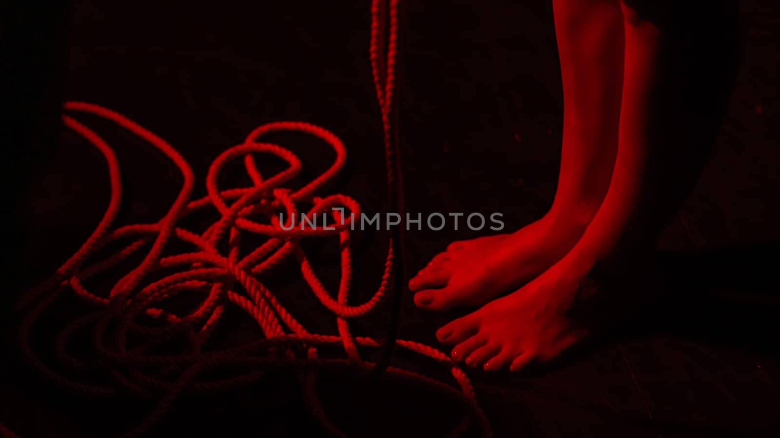 Close-up of woman's feet and ropes. Japanese shibari technique