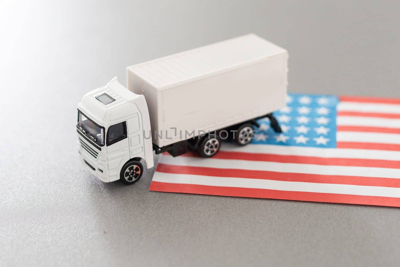 USA Logistics Concept. White Delivery Van on USA Flag background. 3d Rendering. by Andelov13