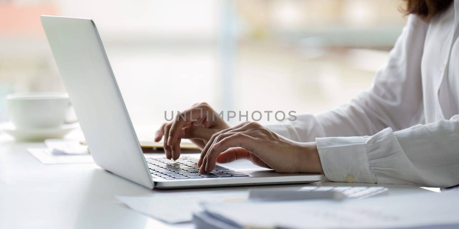 Professional businesswoman working at her office on laptop, work process concept.
