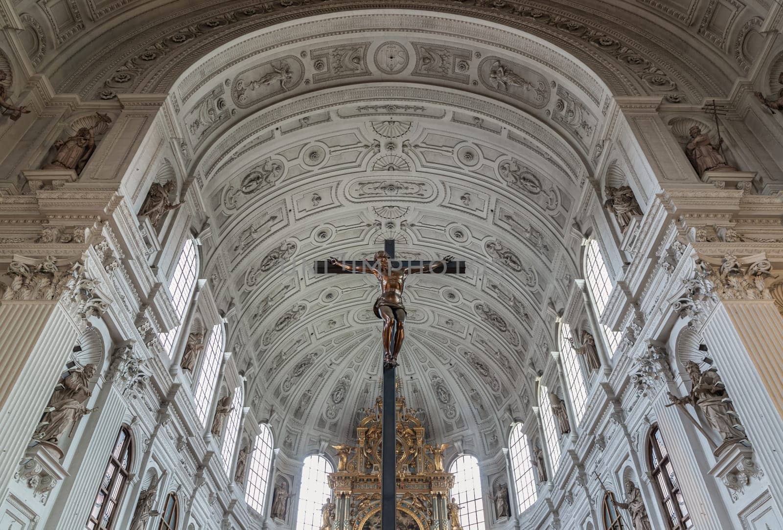 Jesus hanging on the cross, Crucifix in the interior of St. Michael's Church (Michaelskirche Jesuit church) in Munich. by tosirikul