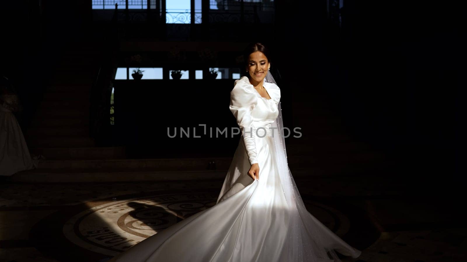 A frantic young bride in a dark corridor. Beautiful young bride in a white dress in a dark interior. by Rusrussid