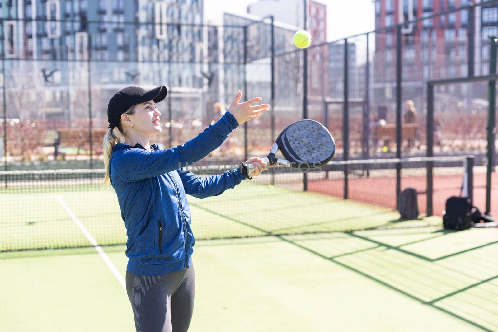 Paddle tennis woman image in court. High quality photo