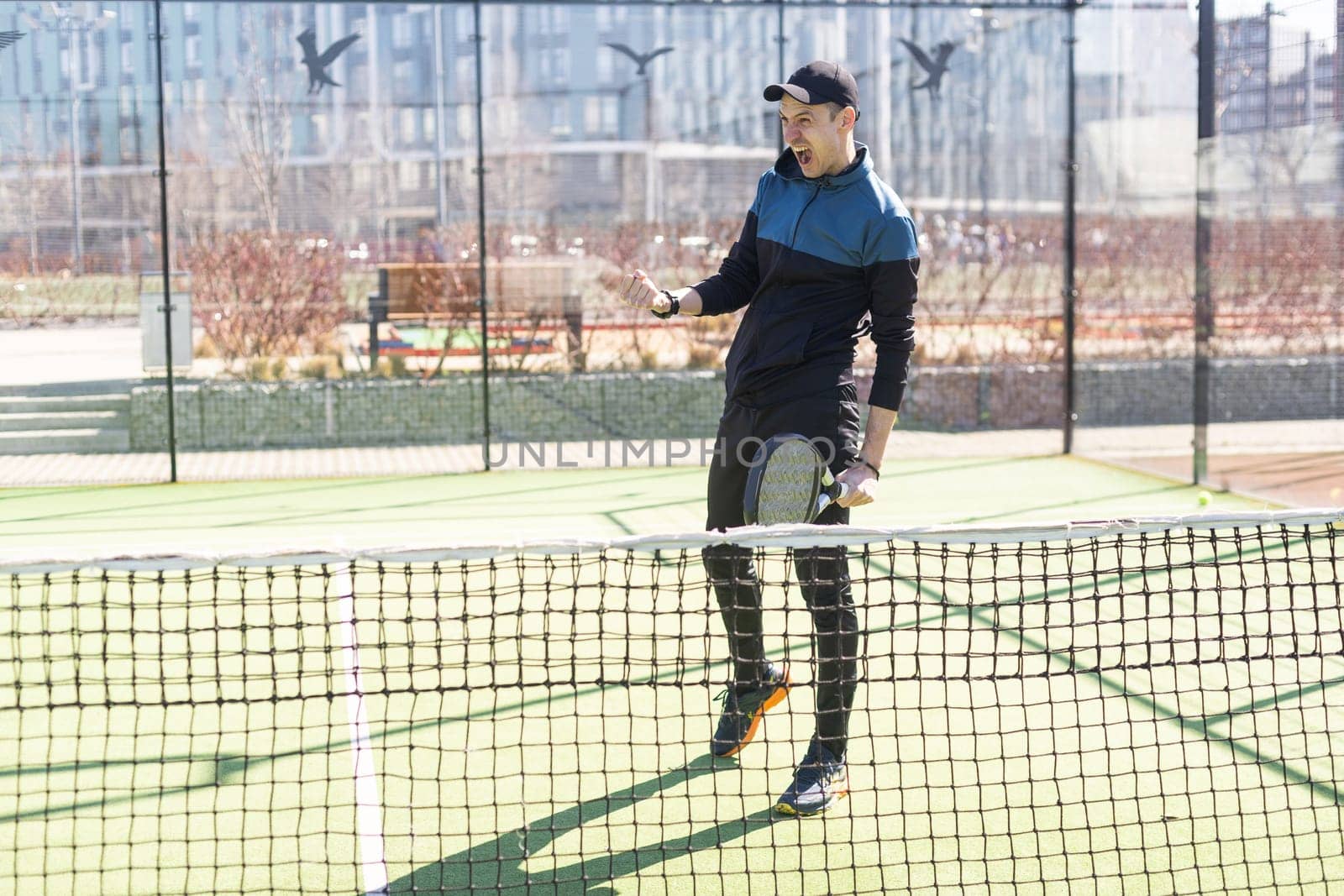 paddle tennis coach teaching on a residential paddle court, front view. High quality photo