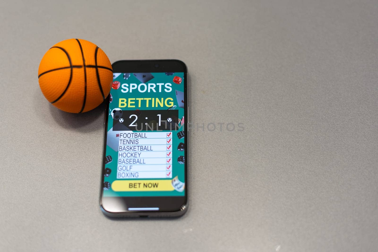 smartphone with application for sport bets and a basketball ball, concept of online bets by Andelov13