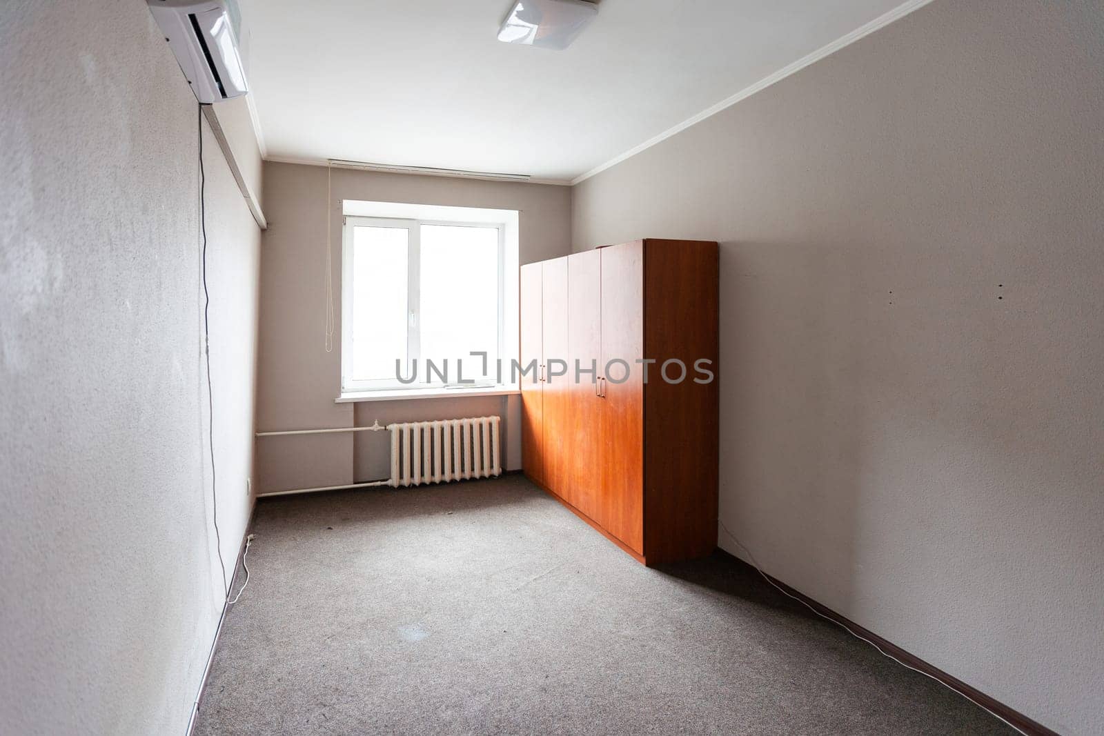 Empty room with all white walls and parquet floor. Nobody inside the room. High quality photo